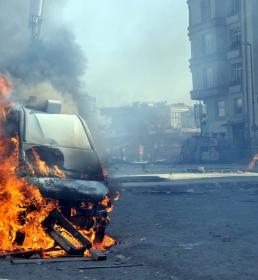 A car burns on a city street